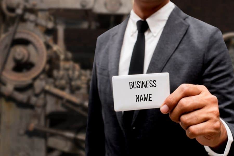 Man in suit holding business card
