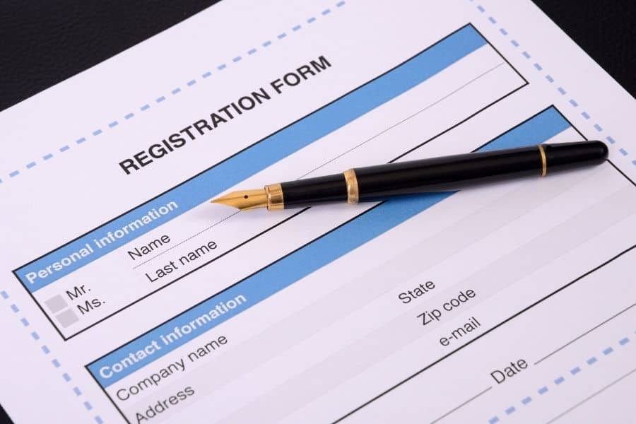 blank registration form with a black pen