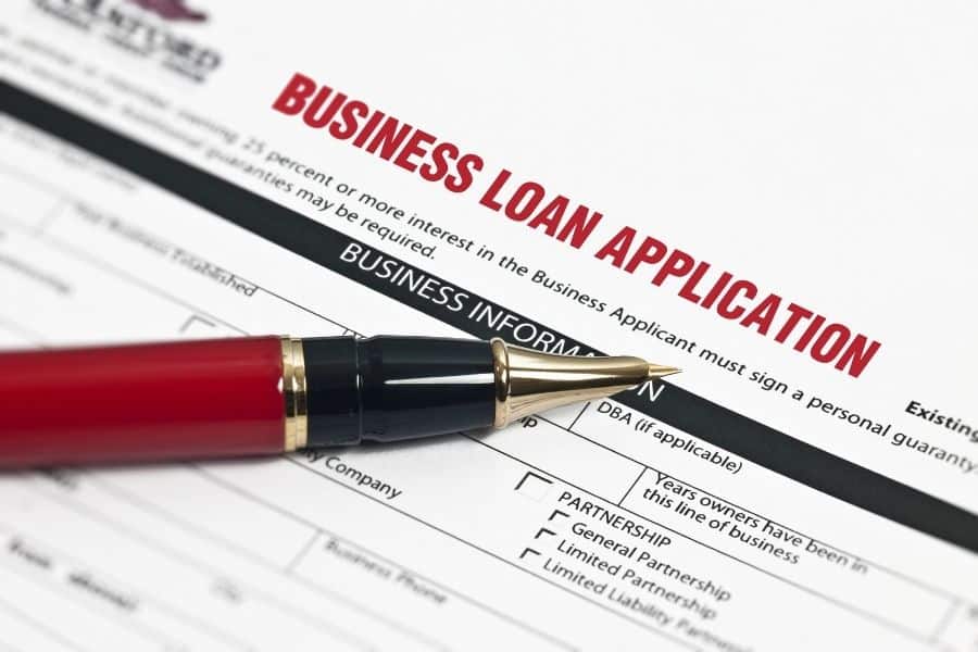 Business loan application form with red pen