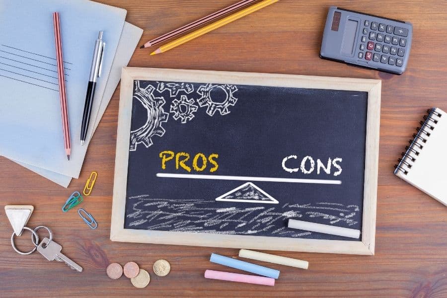 Pros and Cons Balance. Chalkboard on wooden office desk