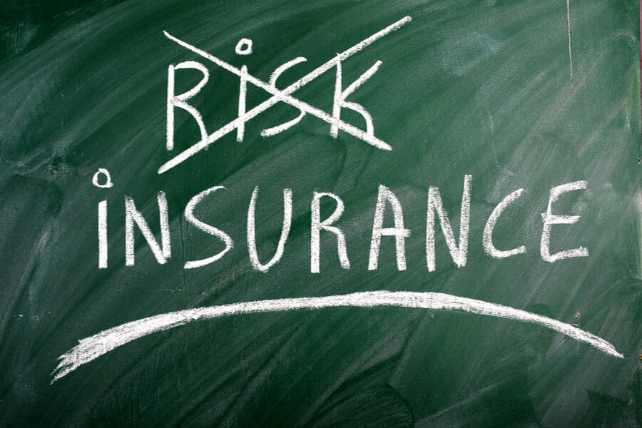insurance risk crossed out green blackboard