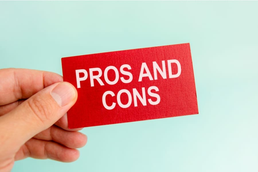 message on the red card with text pros and cons, in hand of businessman, conceptmessage on the red card with text pros and cons, in hand of businessman, concept