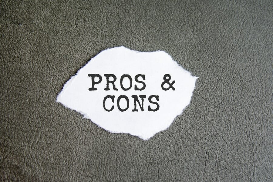 PROS and CONS sign on the torn paper on the gray background, business concept