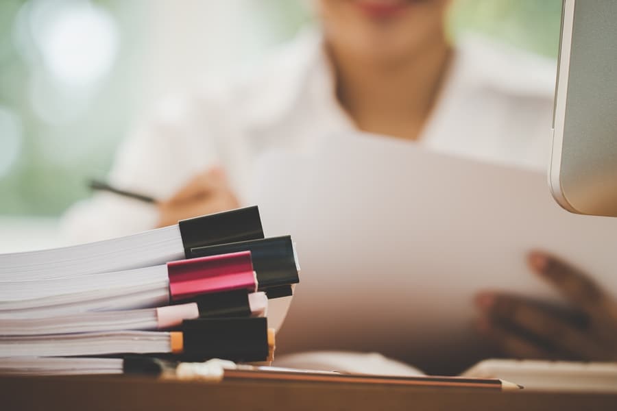 woman arranging documents paperwork
