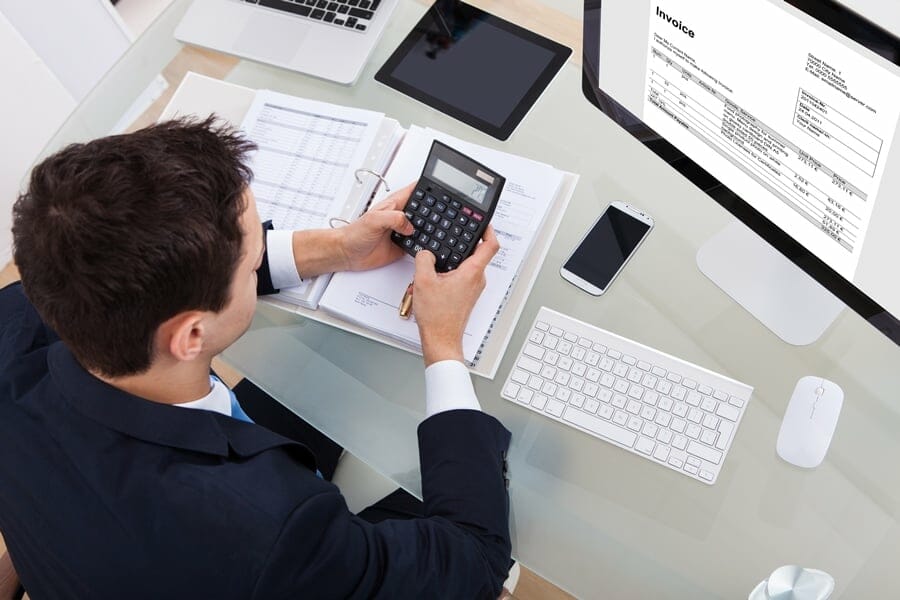 businessman using calculator while working in a desk office