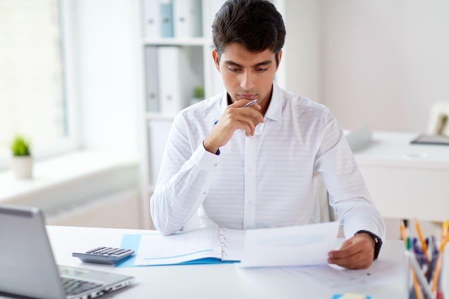 businessman working in the office while doing tally calculation accounting