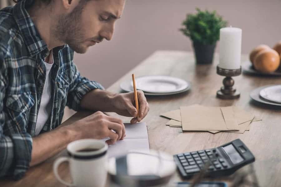 man writing the pros and the cons business ideas