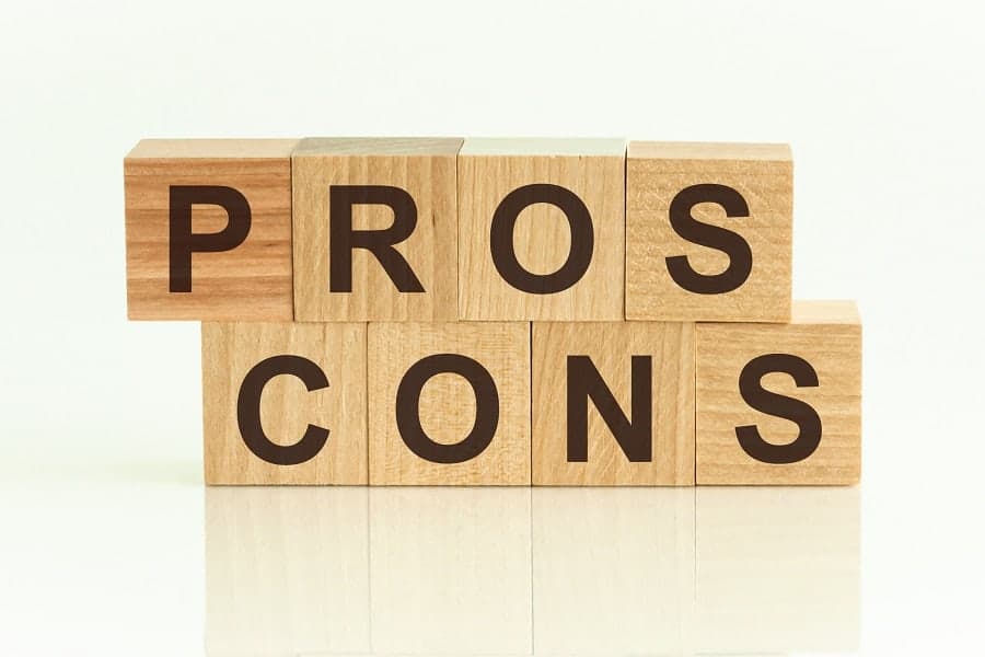 pros and cons text on wooden cubes business concept