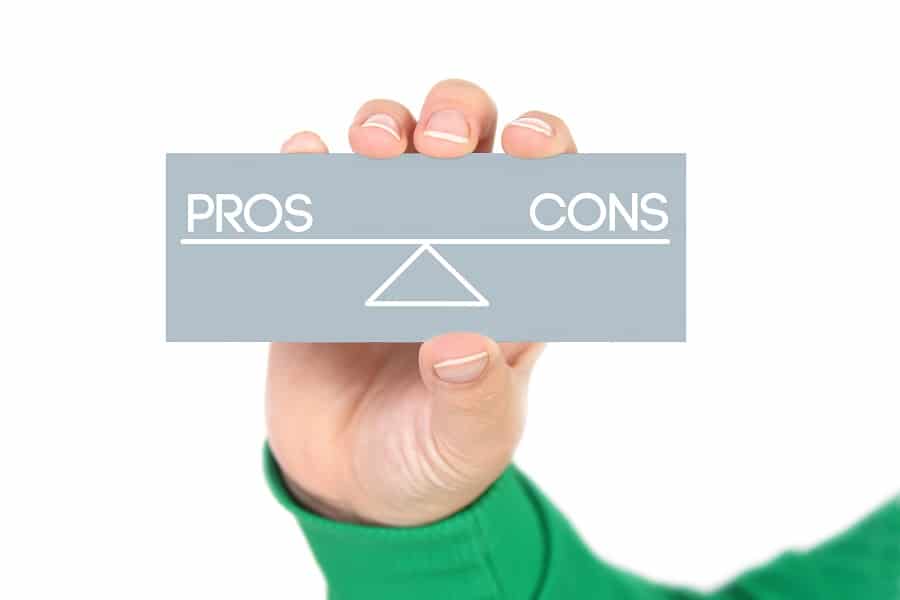 woman holding pros and cons balance concept