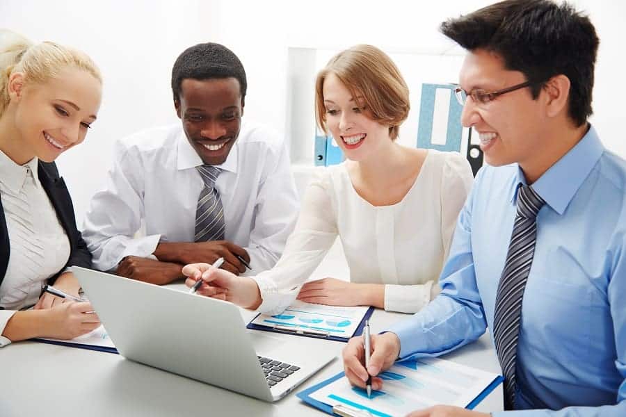 group of business people smiling while discussing business concept