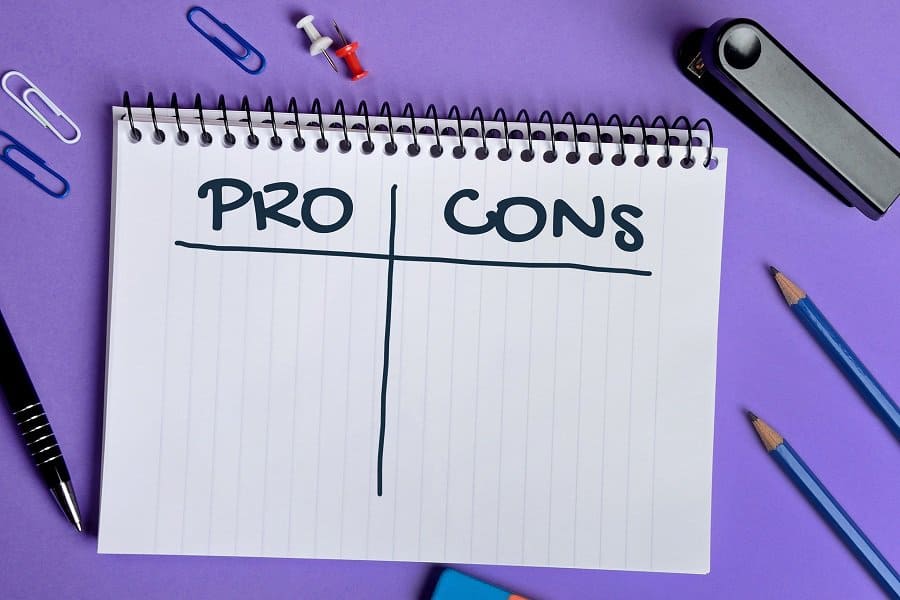written words pros and cons in a notebook