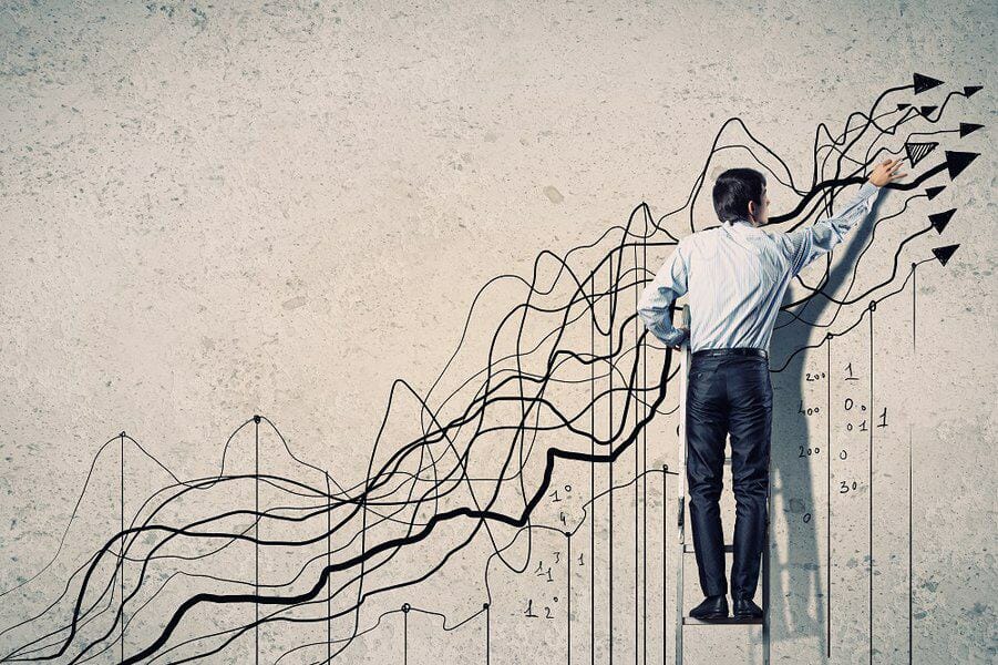 businessman drawing graphics on wall