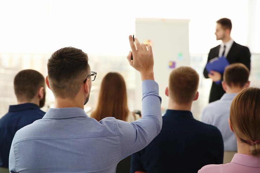 businessman raising hand to ask question