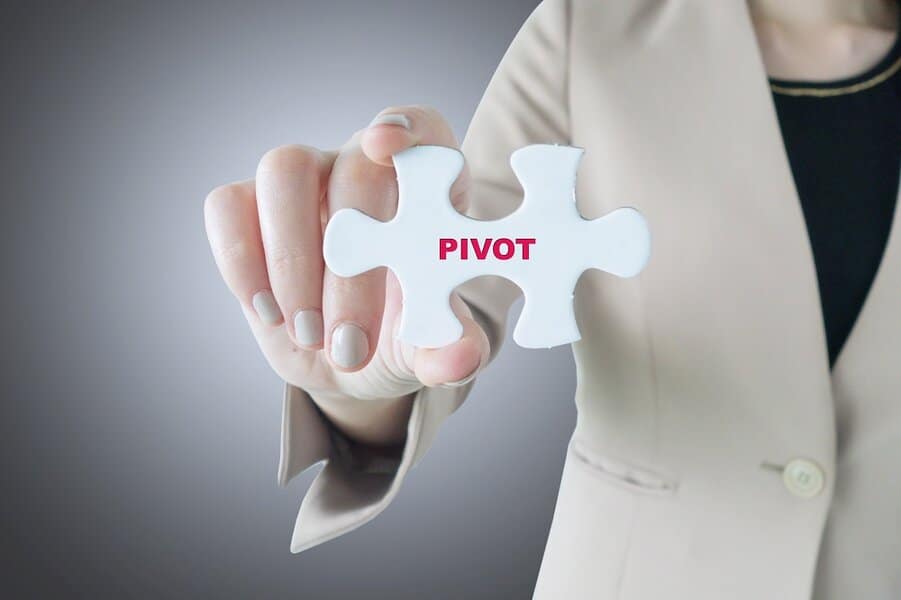 businesswoman holding a word pivot puzzle