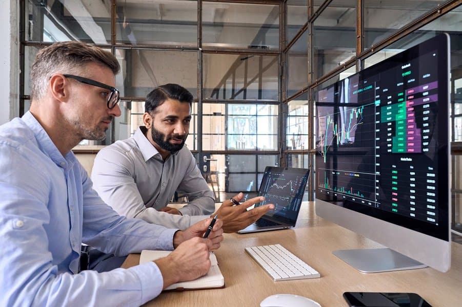 man discussing on trading charts research reports growth